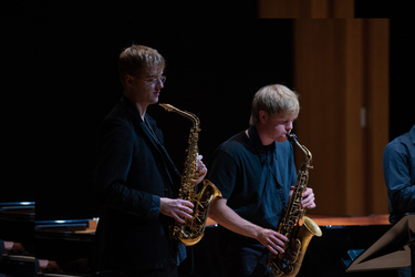 Two students playing the saxophone